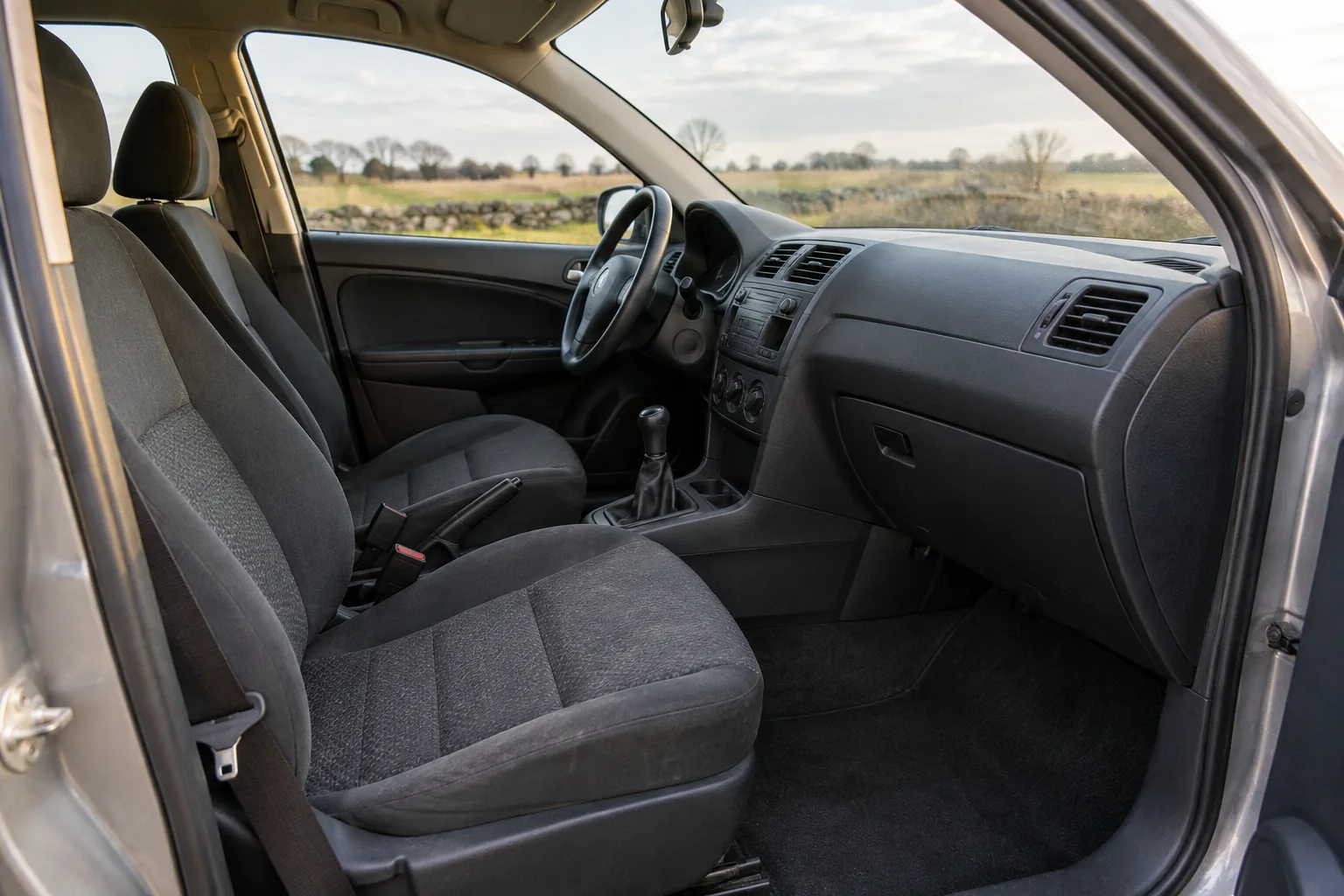 Uncluttered passenger compartment with clear footwell and seat belts